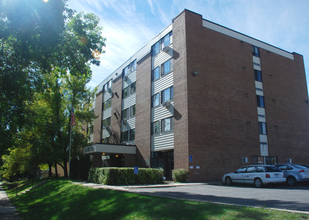 a large brick building with cars parked in front of it